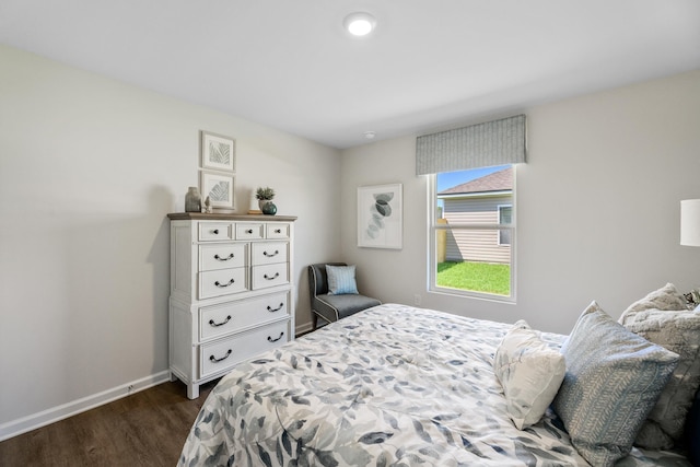 bedroom with dark wood-type flooring