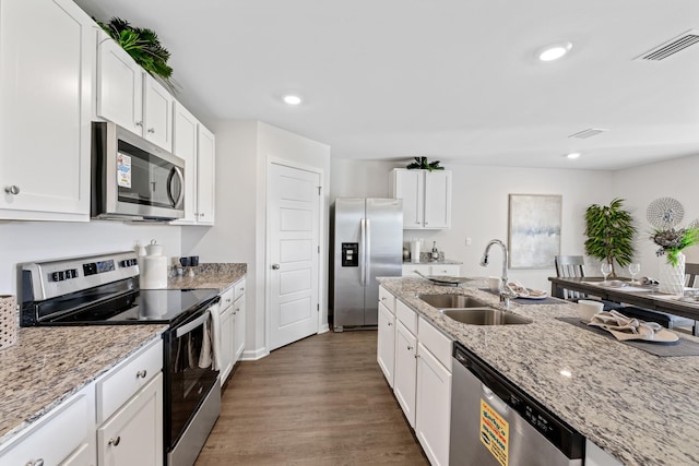 kitchen with white cabinets, sink, light stone counters, and stainless steel appliances