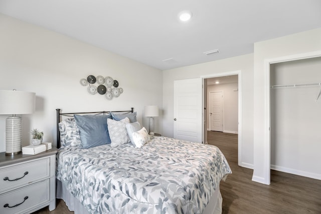 bedroom featuring a closet and dark hardwood / wood-style flooring