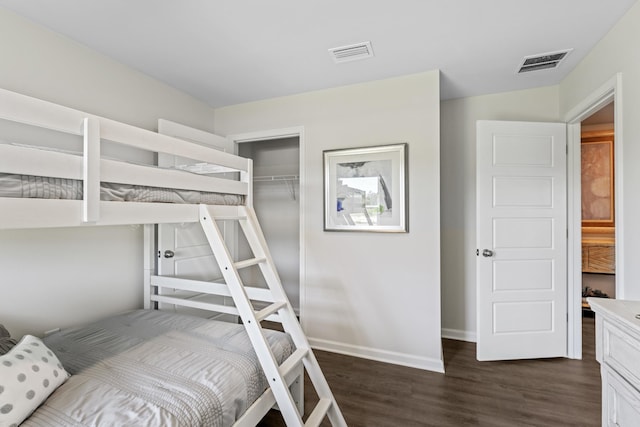 bedroom featuring a closet and dark hardwood / wood-style flooring