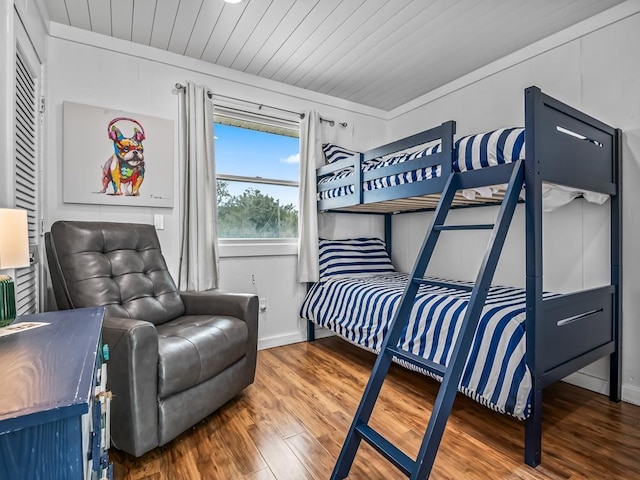 bedroom with hardwood / wood-style floors and wood ceiling