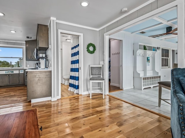 kitchen with crown molding and light hardwood / wood-style flooring