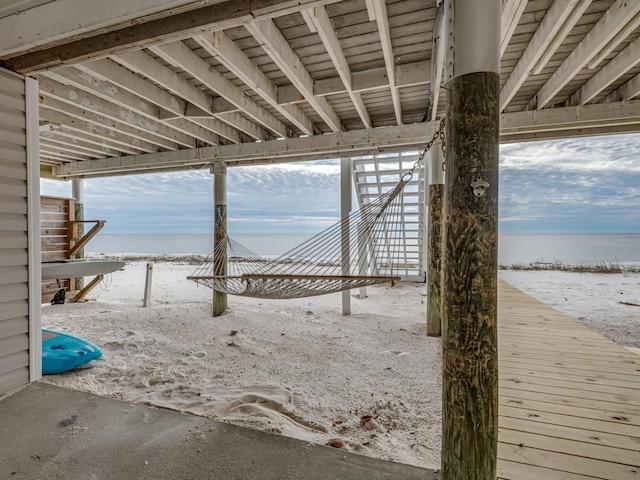 exterior space featuring a beach view and a water view