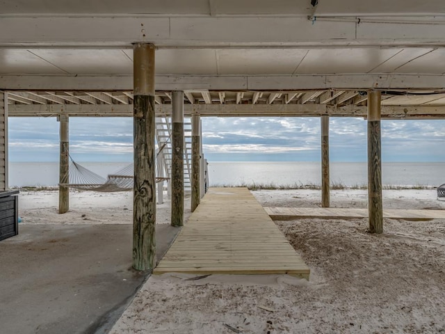 dock area featuring a beach view and a water view