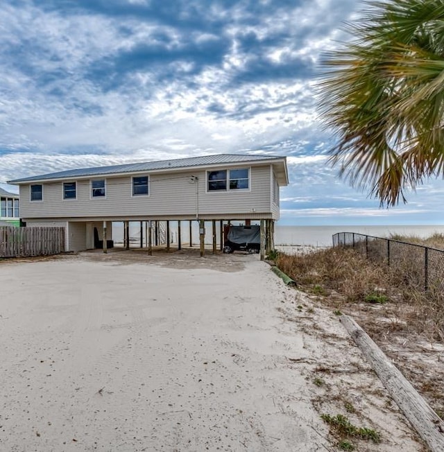 view of front of house with a carport and a water view