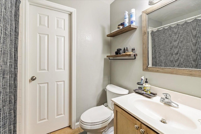 full bath featuring toilet, a shower with shower curtain, and vanity