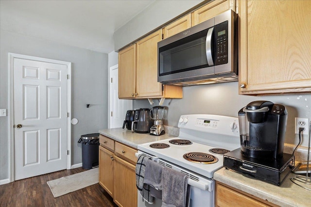 kitchen featuring white electric range, light brown cabinetry, stainless steel microwave, and light countertops