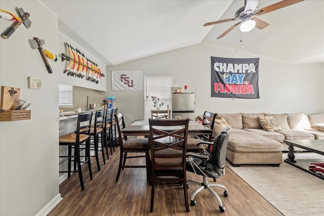 dining room featuring dark wood-style floors, ceiling fan, and vaulted ceiling