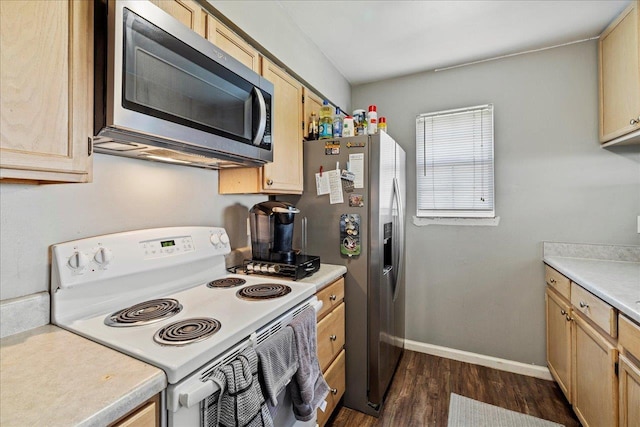 kitchen featuring light brown cabinets, stainless steel appliances, baseboards, light countertops, and dark wood finished floors