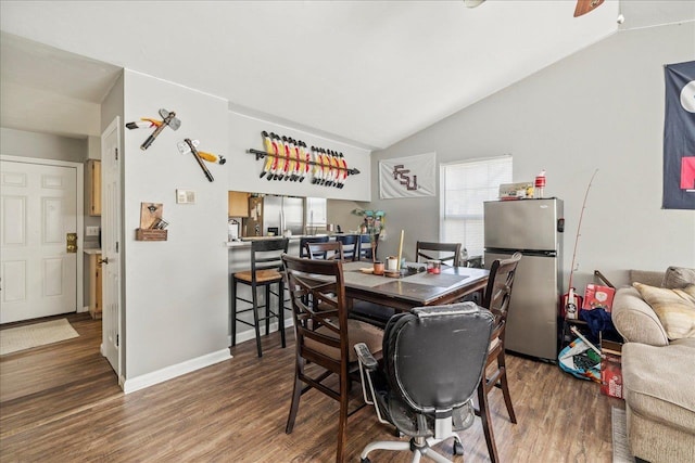 dining area featuring baseboards, vaulted ceiling, and dark wood-type flooring