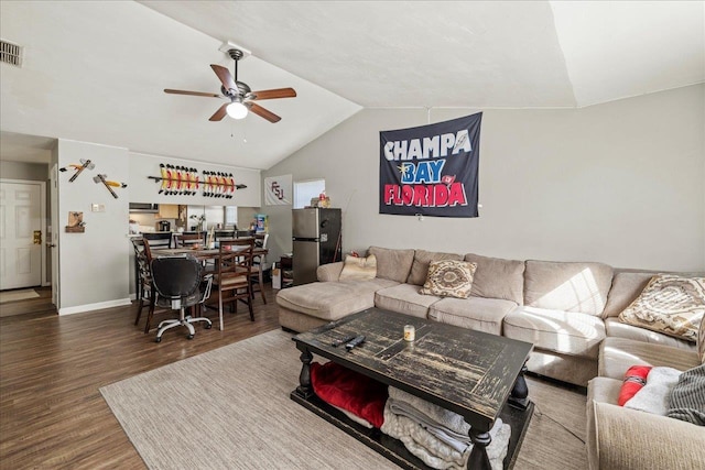 living room featuring baseboards, a ceiling fan, vaulted ceiling, and dark wood finished floors