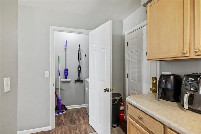 kitchen with light countertops, light brown cabinets, and baseboards