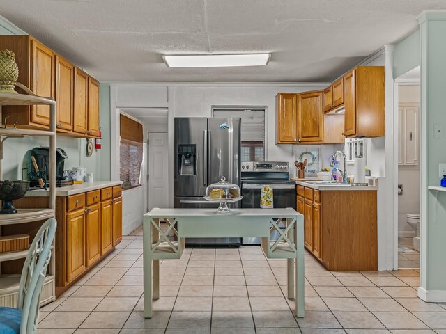 6 Parker Ave Unit 3 & 4, Lanark Village, FL 32323 - kitchen with light countertops, light tile patterned floors, appliances with stainless steel finishes, brown cabinets, and a textured ceiling