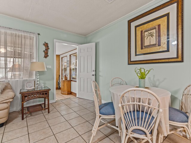 6 Parker Ave Unit 3 & 4, Lanark Village, FL 32323 - dining area with crown molding, light tile patterned floors, and a textured ceiling