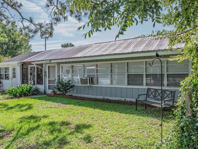 6 Parker Ave Unit 3 & 4, Lanark Village, FL 32323 - single story home featuring a front yard, a metal roof, cooling unit, and a sunroom