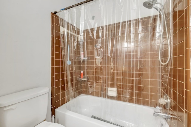 bathroom with shower / bath combination with curtain and toilet