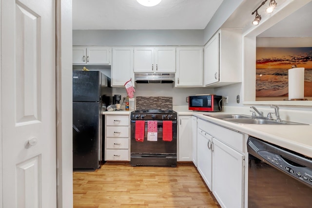 kitchen with light wood-type flooring, sink, white cabinetry, and black appliances