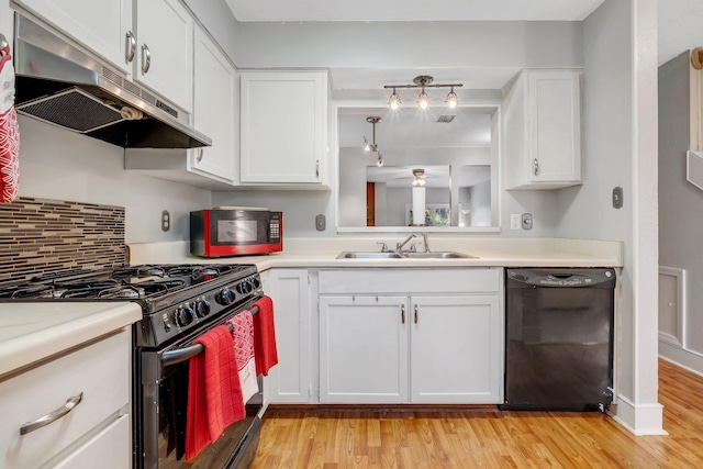 kitchen featuring light wood-type flooring, white cabinetry, and black appliances