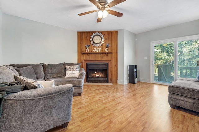 living room with ceiling fan and wood-type flooring