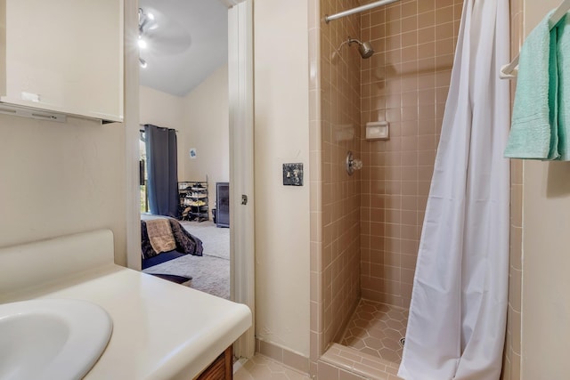 bathroom with a shower with shower curtain, vanity, and tile patterned flooring