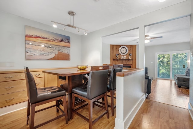 bar with ceiling fan, hanging light fixtures, track lighting, and light wood-type flooring