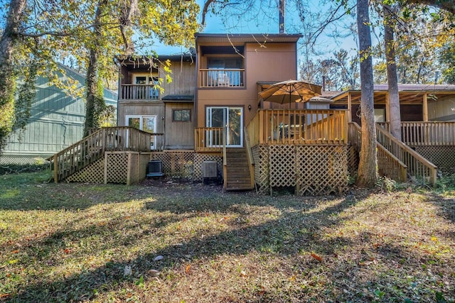 rear view of property with central AC unit, a balcony, a yard, and a deck