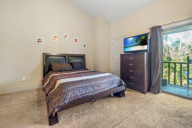 carpeted bedroom featuring access to outside and lofted ceiling