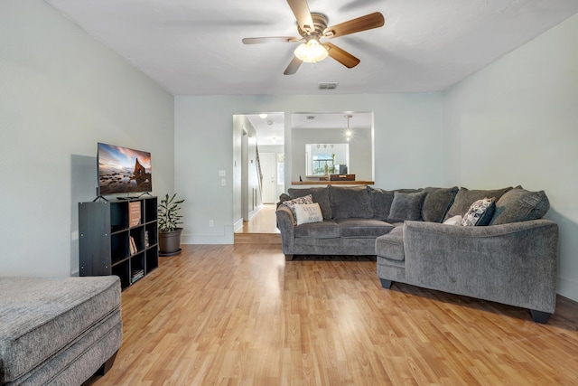 living room featuring ceiling fan and light hardwood / wood-style flooring