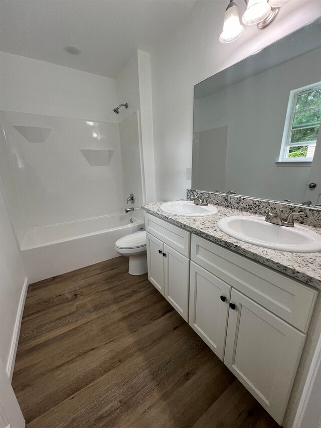 full bathroom featuring toilet, bathtub / shower combination, vanity, and hardwood / wood-style flooring