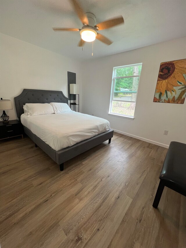 bedroom featuring hardwood / wood-style flooring and ceiling fan