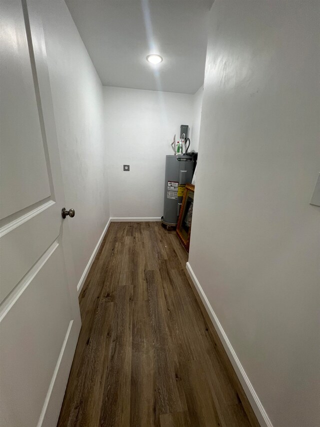 hall featuring water heater and dark hardwood / wood-style floors