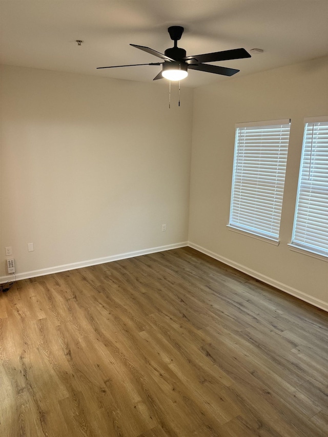 spare room featuring hardwood / wood-style flooring and ceiling fan