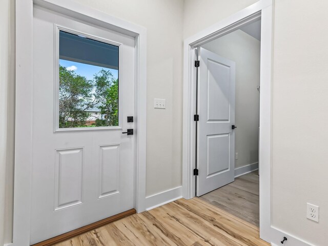 117 Anhinga Trl, Carrabelle, FL 32322 - doorway featuring baseboards and light wood-style flooring