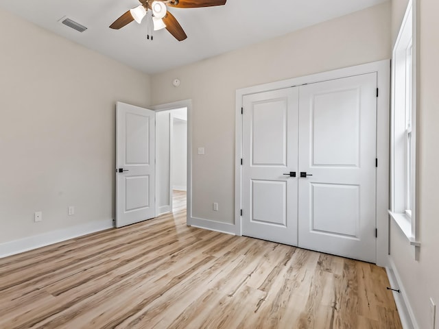 117 Anhinga Trl, Carrabelle, FL 32322 - unfurnished bedroom featuring light wood-style floors, a closet, and a ceiling fan