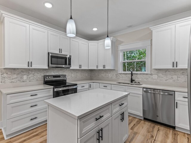 117 Anhinga Trl, Carrabelle, FL 32322 - kitchen featuring appliances with stainless steel finishes, light countertops, tasteful backsplash, white cabinets, and recessed lighting