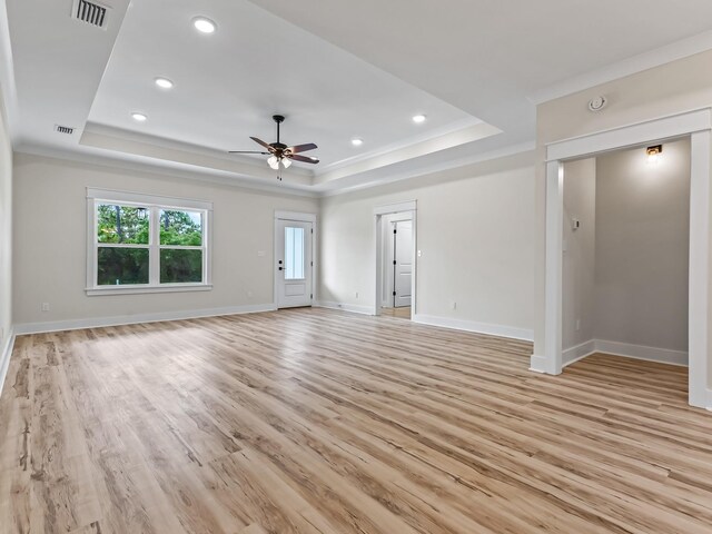 117 Anhinga Trl, Carrabelle, FL 32322 - unfurnished living room with a tray ceiling, ceiling fan, light wood-style flooring, recessed lighting, and crown molding