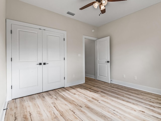 117 Anhinga Trl, Carrabelle, FL 32322 - unfurnished bedroom with light wood-type flooring, a closet, and a ceiling fan