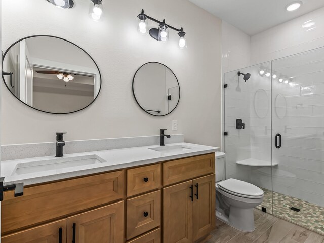 117 Anhinga Trl, Carrabelle, FL 32322 - bathroom with a stall shower, double vanity, wood finished floors, and a ceiling fan