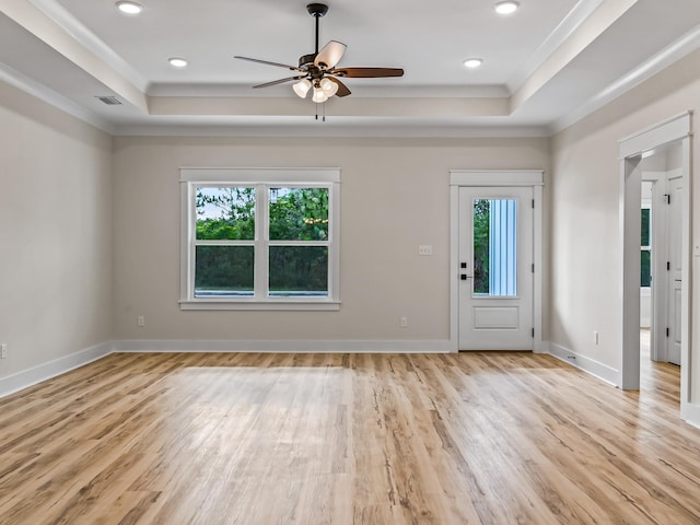 117 Anhinga Trl, Carrabelle, FL 32322 - foyer with a tray ceiling, healthy amount of natural light, light wood-style floors, a ceiling fan, and ornamental molding