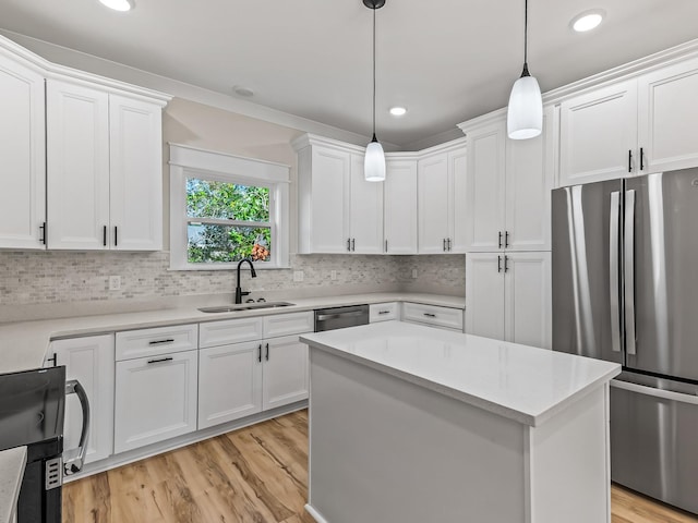 117 Anhinga Trl, Carrabelle, FL 32322 - kitchen featuring appliances with stainless steel finishes, light countertops, white cabinetry, light wood-type flooring, and recessed lighting