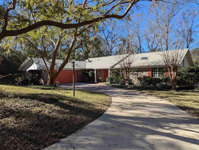 ranch-style home with a garage and a front yard