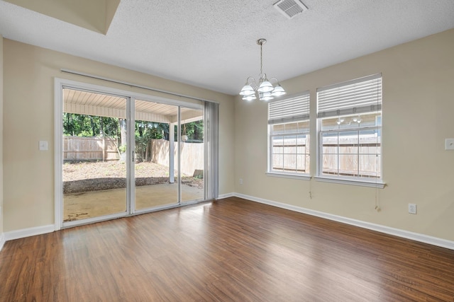1790 Newman Ln, Tallahassee, FL 32312 - unfurnished room with a chandelier, dark wood-style flooring, baseboards, and a textured ceiling