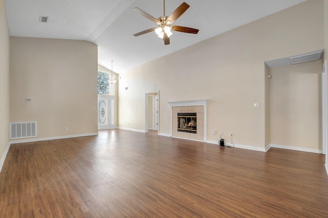 1790 Newman Ln, Tallahassee, FL 32312 - unfurnished living room featuring ceiling fan, wood finished floors, high vaulted ceiling, a tile fireplace, and baseboards