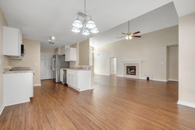 1790 Newman Ln, Tallahassee, FL 32312 - kitchen with appliances with stainless steel finishes, a ceiling fan, open floor plan, white cabinets, and baseboards