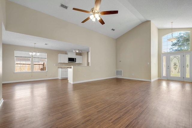 1790 Newman Ln, Tallahassee, FL 32312 - unfurnished living room featuring a chandelier, high vaulted ceiling, healthy amount of natural light, a ceiling fan, and dark wood finished floors