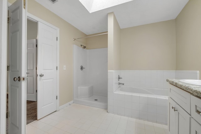 1790 Newman Ln, Tallahassee, FL 32312 - bathroom with a skylight, a shower, tile patterned floors, a bath, and vanity