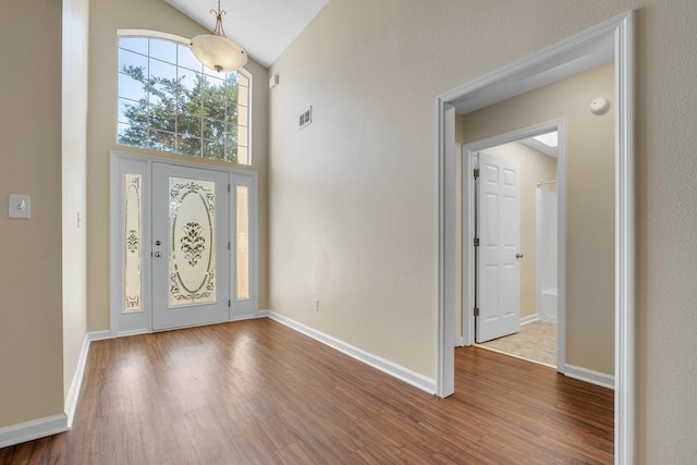 1790 Newman Ln, Tallahassee, FL 32312 - foyer entrance featuring dark wood finished floors, high vaulted ceiling, and baseboards