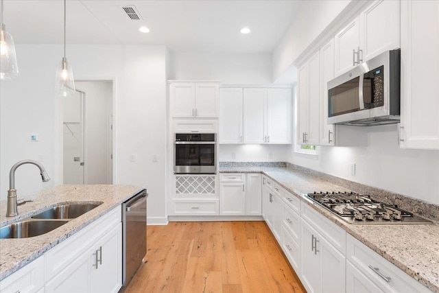 kitchen with white cabinets, sink, and stainless steel appliances