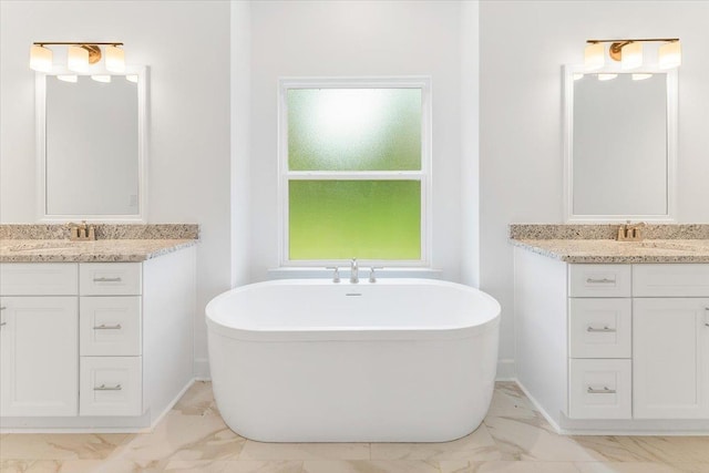 bathroom featuring vanity and a bath