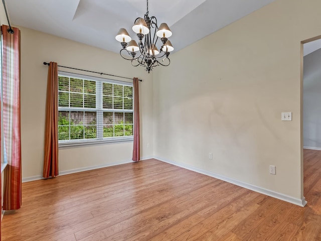 944 Poser Ct, Tallahassee, FL 32317 - unfurnished room featuring a chandelier and wood finished floors